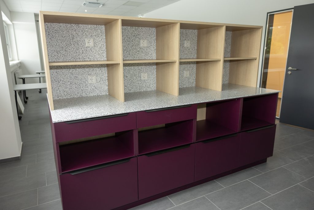 Offene Küchenzeile mit Regalaufsätzen und dunkler Arbeitsplatte